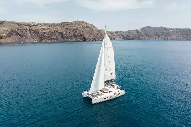 Santorini Luxury Sailing Catamaran Cruise with BBQ, Drinks and Transfer